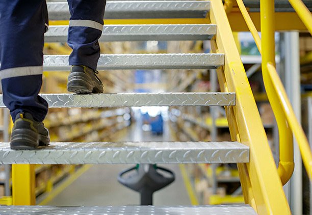 Hombre subiendo escalones de lámina antiderrapante