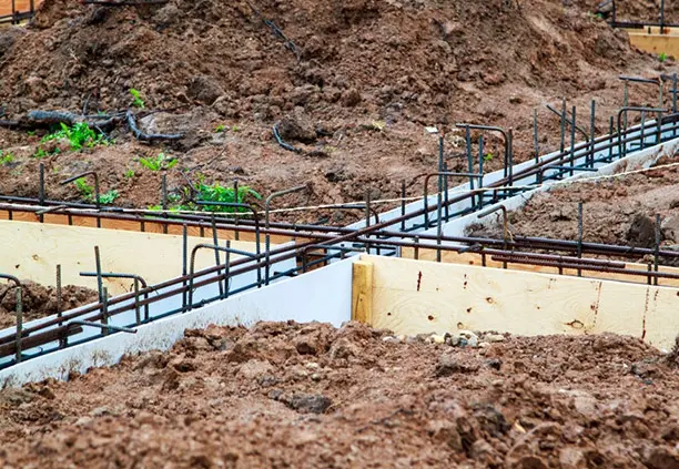 Estructura de varilla de acero colocada sobre el suelo y rodeada de tablas de madera